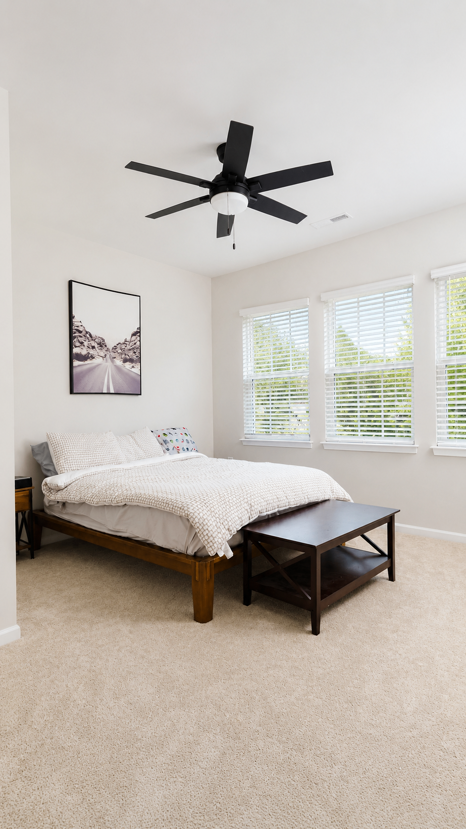Bedroom with ceiling fan and bright corner windows