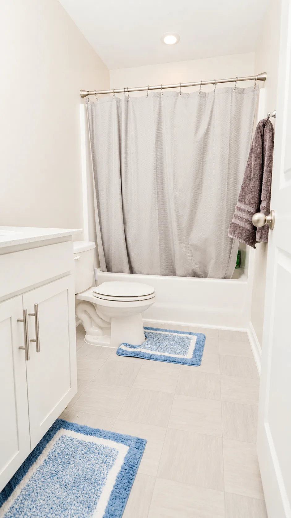 Secondary full bathroom at 222 Lothian with tub-shower combo and white vanity
