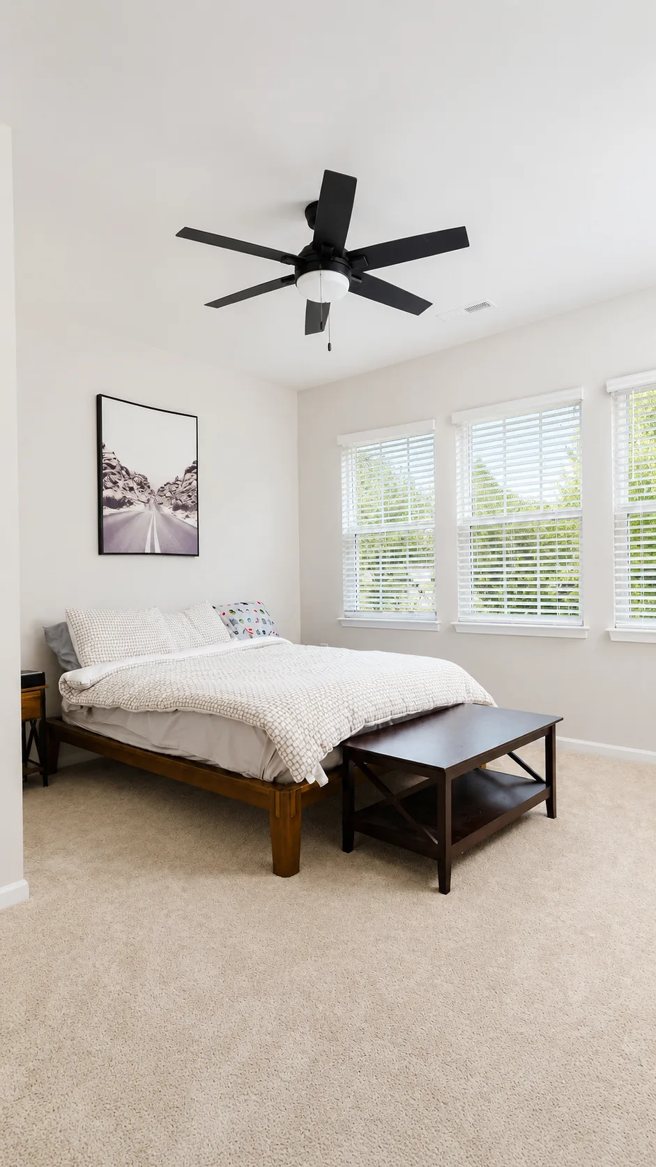 Secondary bedroom at 222 Lothian with ceiling fan and bright corner windows