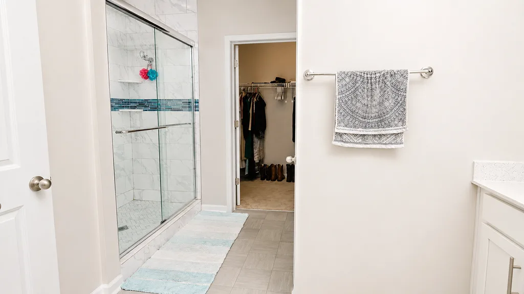 Primary bathroom at 222 Lothian with an updated tile and glass shower