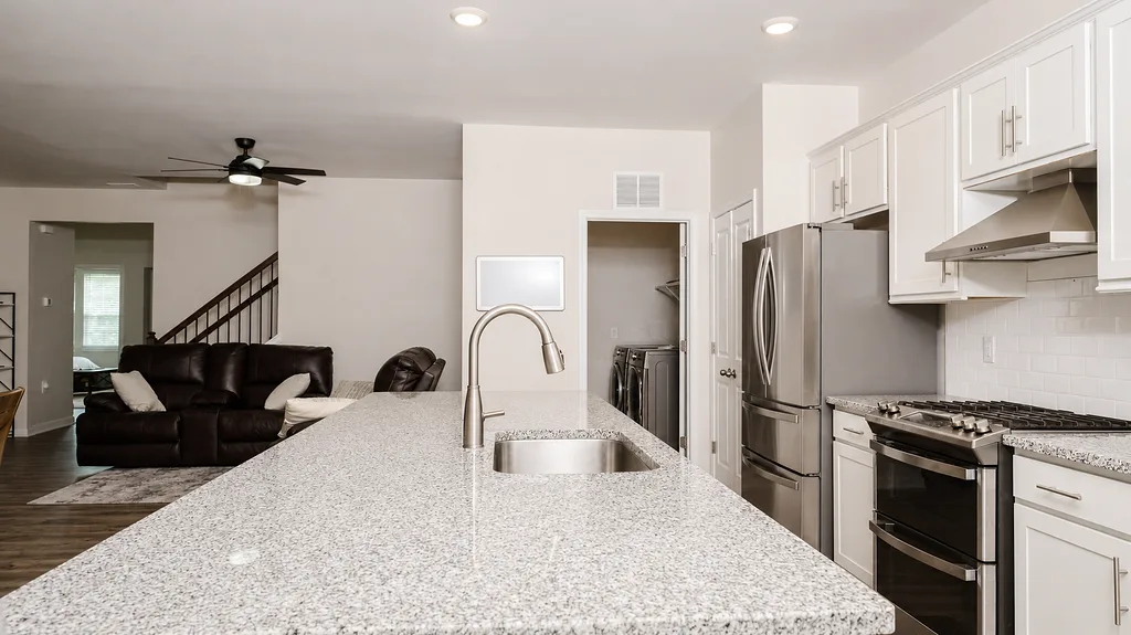 Kitchen at 222 Lothian with granite island, gas range and stainless steel appliances